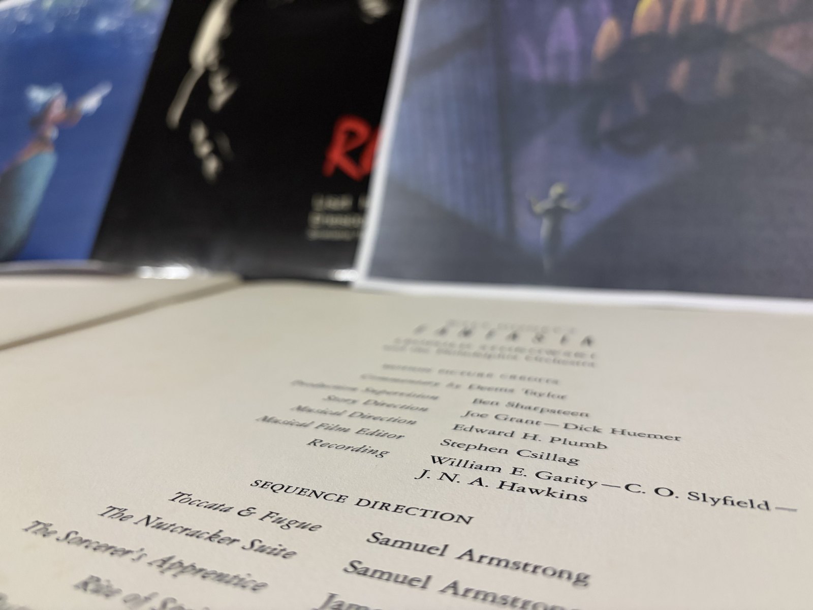 說明冊的電影製作名單頁，Recording 一欄印著 Garity、Slyfield 與 Hawkins——Fantasound 的錄音團隊，名字就在這一行。模糊的背景是米奇指揮家交棒給 Stokowski。